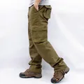 Professional men's loose fit multi-pocket cargo pants in khaki color shown from a side view. - 38 / Bottoms / Military Yellow
