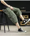 Close-up view of olive green cargo capri pants highlighting the side pocket detail - 4XL / Bottoms / Army Green