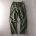 Detail view of men's olive green outdoor cargo pants with multi-pockets and adjustable hems - 2XL / Bottoms / Army Green