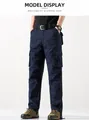 Detalle de pantalones cargo azul oscuro duraderos para hombre con varios bolsillos - Azul marino