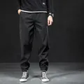 Men's fleece-lined black jogger pants with elastic cuffs for warm winter wear - M / Bottoms / Winter Fleece Lined / Black