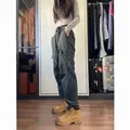 Woman wearing dark techwear cargo pants and tan hiking boots in a dressing room - S / Bottoms / Spring and Autumn Mid-thick Style / Gray
