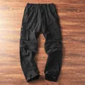 Detaillierte Ansicht einer wandelbaren schwarzen Tactical-Cargohose mit Reißverschluss. - S / Unterteile / Schwarz