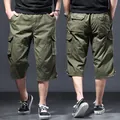 Loose fit men's olive green cotton cargo shorts in 3/4 length with functional pockets - M / Army Green