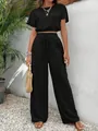 Detail view of a black textured two-piece set with short sleeve top and wide pants - S / Top And Bottom / Black