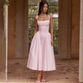 Full view of a pink gingham midi dress with a square neckline and voluminous skirt - XS / Pink