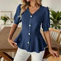 Close-up showing the textured fabric and button detail of a blue puff sleeve blouse. - Dark Blue