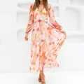 Close-up of bohemian floral maxi dress with deep V-neck and long sleeves - S / Top (4) / Orange Pink Print