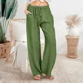 A full-length detail shot of loose cotton-linen wide-leg casual trousers in an olive green shade - S / Bottoms / Green