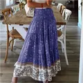 Detailed view of bohemian floral maxi skirt with high smocked waist and printed hem - S / Bottoms / Purple