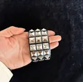 Close-up of punk black leather bracelet with four rows of silver square pyramid studs - Triple Row / Square Rivets / Black