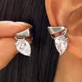 Close-up of elegant silver twisted line ear cuff featuring a sparkling pear-shaped zircon stone. - 1 Pair / Silver