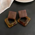 Detail view of retro wood and amber resin diamond drop earrings on black background - Silver Earring Post Style / Coffee