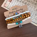 Detailed macro view of vintage elastic bracelet set featuring natural wood beads and turquoise accents. - Coffee-White
