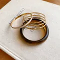 Close-up of resin and gold-plated metal bracelet set with glitter details - Five-Piece Set / Gold Brown
