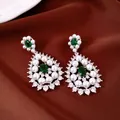 Elegant drop earrings featuring lustrous white pearls and emerald green gemstones on satin - Earrings Only (Without Necklace)