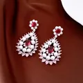 Detail shot of teardrop pearl earrings with red zircon accents on brown silk background - Earrings Only (Without Necklace)