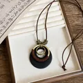 Detailed view of an ethnic style geometric resin necklace in a wooden jewelry box tray - Vintage Round Wrapped Style (2#)