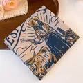 Close-up of vintage Western cowboy and longhorn print on polyester square headscarf - Western Cowgirl Portrait Style / Blue-Grey
