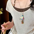 Close-up of a handmade crochet straw hat necklace with colorful flowers and beads. - Straw Hat Style (1) / Brown-Multicolor