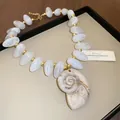 Gros plan sur les perles en acrylique marbré blanc et le grand pendentif en nautile. - Collier Pendentif Coquillage Motif Marbre / 4# collier - blanc - conque