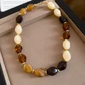 Close-up of acrylic chunky beaded necklace in amber, cream, and dark brown tones. - Milky White Amber Coffee Multicolor Geometric Beaded Necklace / 18# Necklace - Brown