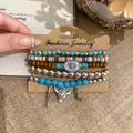Detail of boho beaded bracelet set with bull head and feather charms in ethnic style. - Brown Blue