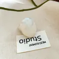 Close-up of a white jelly-colored resin oval ring on a textured minimalist canvas background - 41# Marble Milk White