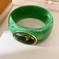 Detail shot of a green marble-patterned resin bangle with an oval cabochon accent - Geometric Open Style (39#)