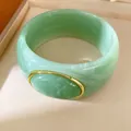 Detailed macro view of the green resin bangle featuring a gold-trimmed oval accent - Geometric Open Style (40#)