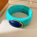 Detail view of a vintage turquoise resin bangle featuring a blue stone in gold setting - Geometric Open Style (41#)