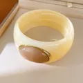 Detailed view of a cream resin chunky bangle featuring a rose-colored oval stone. - Geometric Open Style (45#)