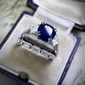 Close-up detail of luxury deep blue cushion cut zircon engagement ring set in a vintage velvet box - Size 5 / Cushion Cut Deep Blue Style (CY964)