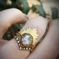 Detailed view of a gold-tone sunburst stacking ring set with a clear hexagonal zircon - Size 5 / Gold Layered Skull Style (CY909)