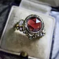 Detailed macro view of vintage gold ring featuring a large red zircon and skull accents - Size 5 / Round Red Zirconia Gothic Skull Style (CY895)