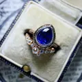 Close-up of vintage pear-cut blue zircon ring with V-shaped diamond band - Size 5 / Sapphire Blue Zirconia Two-Piece Set (CY894)