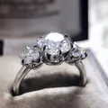 Detailed macro shot of a shiny silver three-stone cubic zirconia engagement ring. - Size 5 / Three-Stone White Rhinestone Style (CY805)