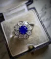 Detailed macro view of vintage style floral engagement ring with a blue sapphire center stone - Size 6 / Blue Sunflower Style (CY778)