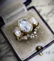 Close-up of a vintage-style gold engagement ring set with oval cubic zirconia stones. - Size 6 / Three-Stone Vintage Style (CY737)