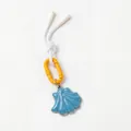 Close-up view of blue shell charm pendant with orange carabiner and white cord - Blue Scallop Charm