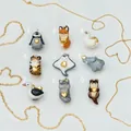 Collection of nine cute animal pendants with gold heart details and gold chains - Penguin Shape Pendant / Colorful