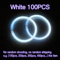 White glowing neon glow stick bracelets set against a dark background for parties - White