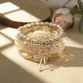 Elegant Bohemian stacked bracelet set featuring faux pearls and a delicate golden bow charm - Stackable Bracelet Set / Yellow