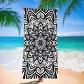 Detailed black and white mandala print on a microfiber beach towel at a tropical beach - 120x60cm / Black and White Mandala Pattern