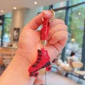 Porte-clés créatif patins à roulettes strass rouges avec lanière en cuir et anneau doré - Rouge