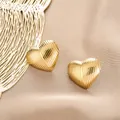 Elegant gold ribbed heart-shaped stainless steel stud earrings for fashionable women - Striped Heart Style (E1261-A) / 1 Pair Pack / Gold
