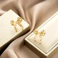 Elegant gold bow-shaped stainless steel stud earrings for women in a luxury finish - Wavy Bow-knot Style (E1266-A) / 1 Pair Pack / Gold