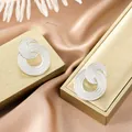 Elegant silver textured double-layered stainless steel stud earrings on gold jewelry boxes - Overlapping Rings Grainy Style (E1307-B) / 1 Pair Pack / Steel