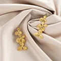 Elegant gold stainless steel triple flower earrings on luxurious champagne satin cloth - Three-layer 3D Floral Style (E1339-A) / 1 Pair Pack / Gold