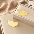 Elegant gold ginkgo leaf stud earrings made of stainless steel displayed on a gift box - Ginkgo Leaf Vein Style (E1325-A) / 1 Pair Pack / Gold